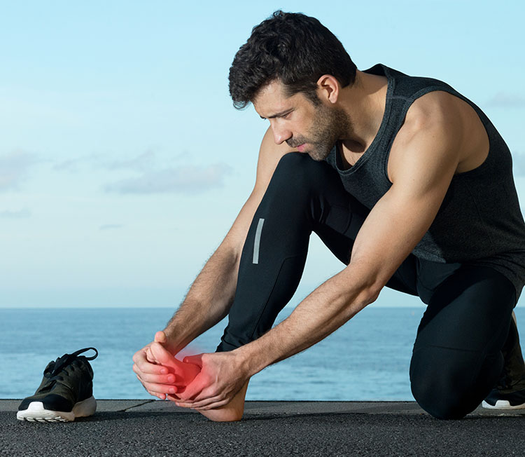 man holding his feet